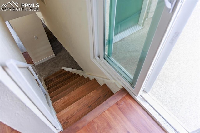 stairs with wood finished floors