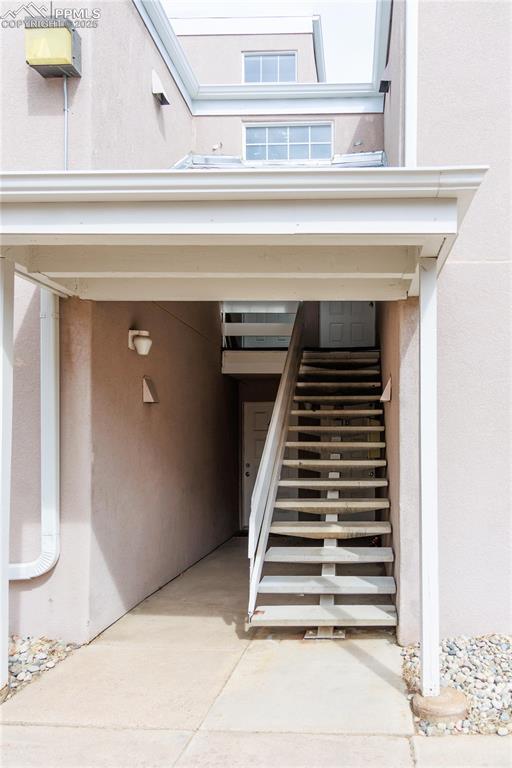 exterior space with stucco siding and an attached garage