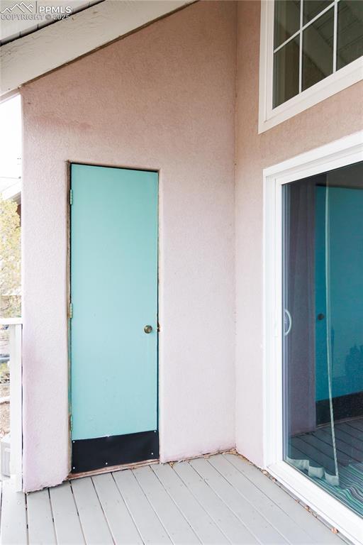 doorway to property with stucco siding
