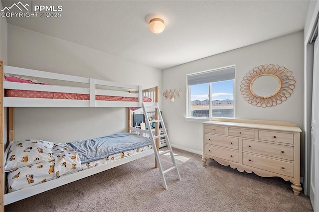 bedroom featuring carpet floors and baseboards