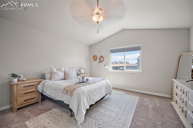 bedroom with baseboards, vaulted ceiling, light carpet, and ceiling fan