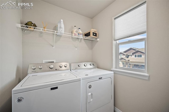 laundry room with separate washer and dryer and laundry area