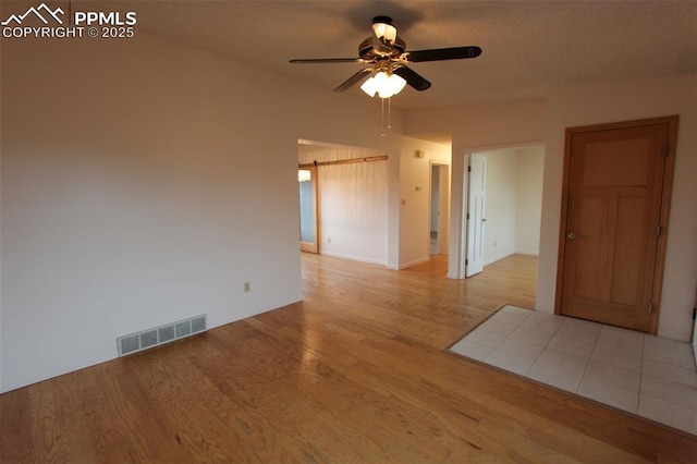 2380 Stepping Stones Way, Colorado Springs, CO 80904 - unfurnished room with visible vents, wood finished floors, and ceiling fan