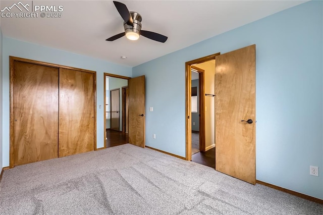 unfurnished bedroom with baseboards, ceiling fan, a closet, and carpet floors