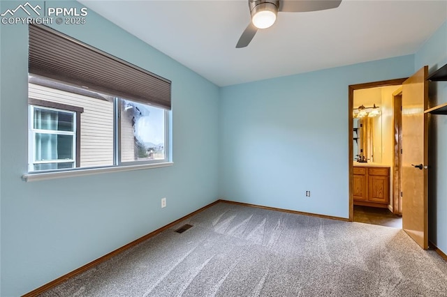 unfurnished bedroom with visible vents, baseboards, ceiling fan, connected bathroom, and carpet floors