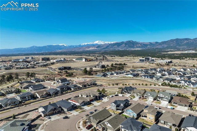 birds eye view of property with a mountain view and a residential view
