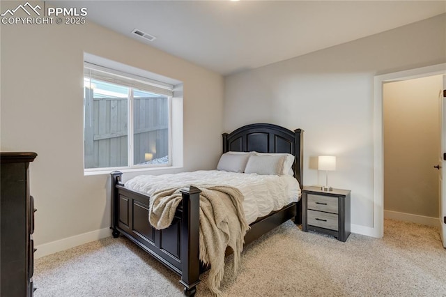 bedroom featuring light carpet, baseboards, and visible vents