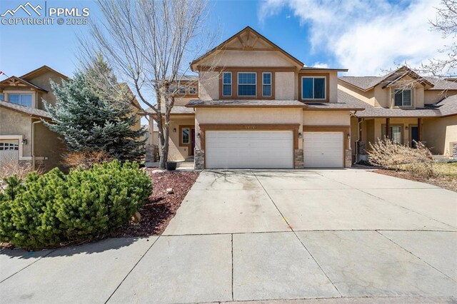 4454 College Park Ct, Colorado Springs, CO 80918 - view of front of home with stucco siding, an attached garage, stone siding, and concrete driveway