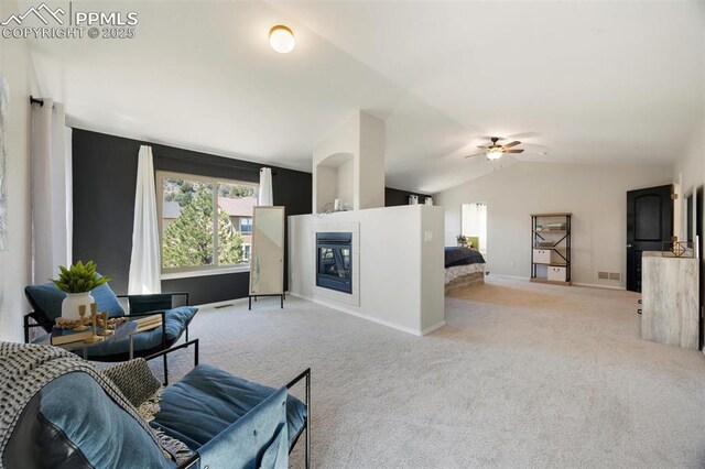 4454 College Park Ct, Colorado Springs, CO 80918 - carpeted living room featuring lofted ceiling, baseboards, visible vents, a ceiling fan, and a tile fireplace