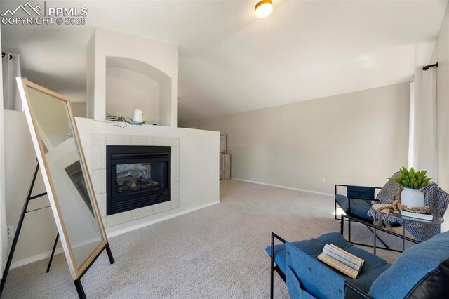 4454 College Park Ct, Colorado Springs, CO 80918 - sitting room with carpet floors, a tile fireplace, baseboards, and vaulted ceiling