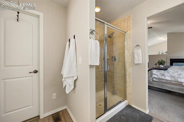 4454 College Park Ct, Colorado Springs, CO 80918 - bathroom with visible vents, a shower stall, baseboards, ensuite bath, and vaulted ceiling