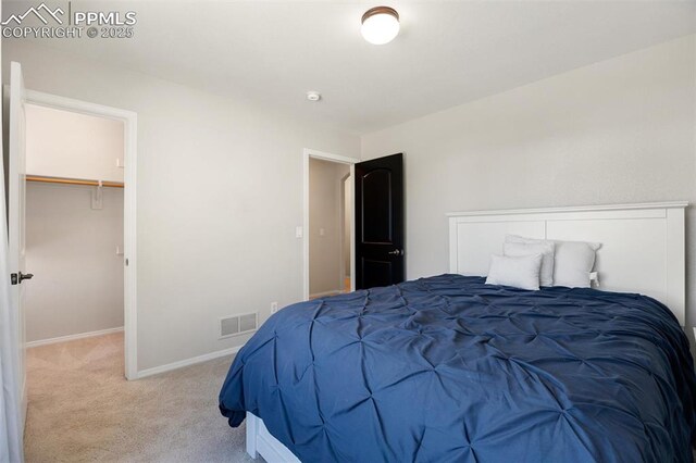 4454 College Park Ct, Colorado Springs, CO 80918 - carpeted bedroom with a walk in closet, baseboards, and visible vents