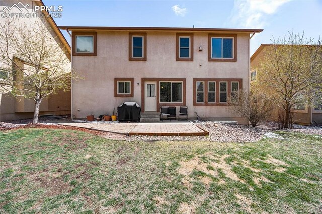 4454 College Park Ct, Colorado Springs, CO 80918 - back of house featuring stucco siding, a patio area, entry steps, and a yard