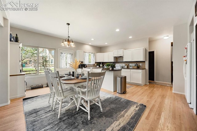 4454 College Park Ct, Colorado Springs, CO 80918 - dining space with baseboards, a notable chandelier, light wood-style flooring, and recessed lighting