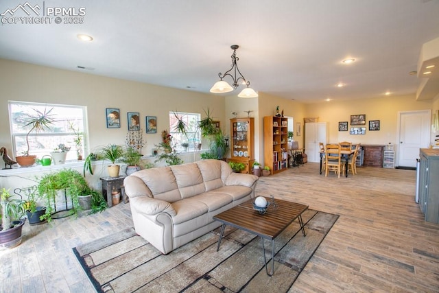 17035 Herring Rd, Colorado Springs, CO 80908 - living room with visible vents, a wealth of natural light, recessed lighting, and wood finished floors