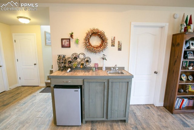 17035 Herring Rd, Colorado Springs, CO 80908 - kitchen with wood finished floors, a sink, and baseboards