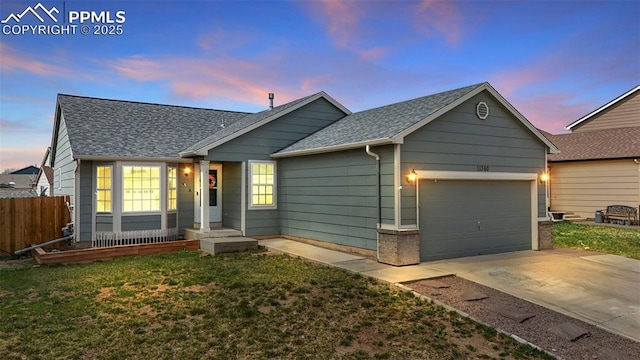 ranch-style home featuring concrete driveway, an attached garage, fence, and roof with shingles