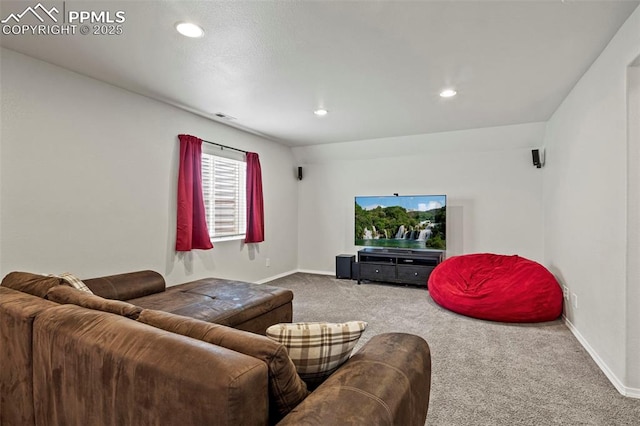carpeted living area featuring baseboards, visible vents, and recessed lighting