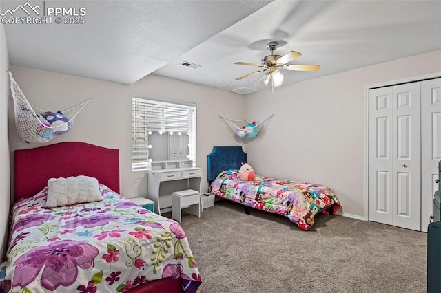 carpeted bedroom featuring ceiling fan, visible vents, and a closet