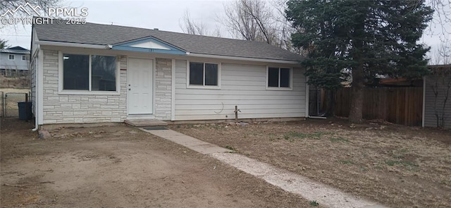 131 Hayes Dr, Colorado Springs, CO 80911 - view of front of home featuring stone siding and fence