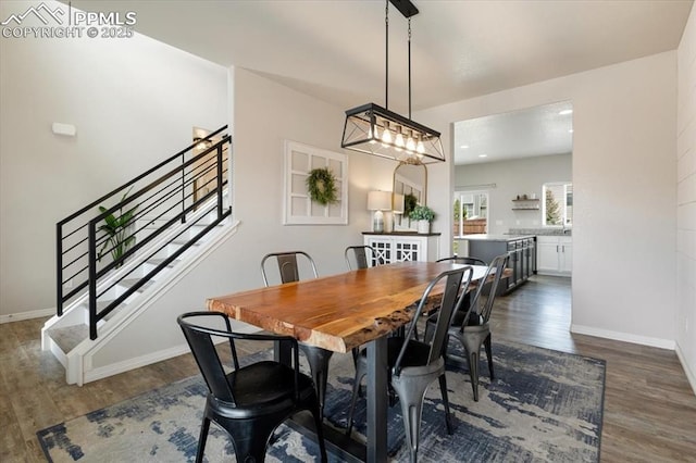 13424 Stone Valley Dr, Peyton, CO 80831 - dining room with dark wood-style flooring, baseboards, and stairway