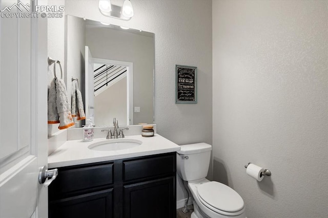 13424 Stone Valley Dr, Peyton, CO 80831 - bathroom featuring toilet, vanity, and a textured wall