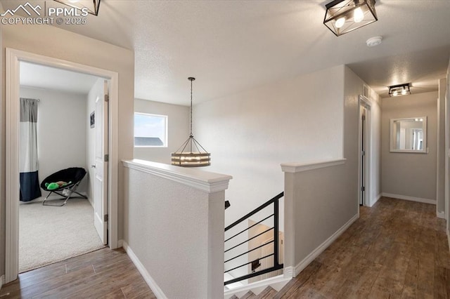 13424 Stone Valley Dr, Peyton, CO 80831 - hallway with wood finished floors, baseboards, and an upstairs landing