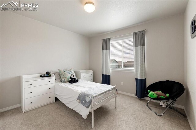 13424 Stone Valley Dr, Peyton, CO 80831 - bedroom with baseboards and light colored carpet