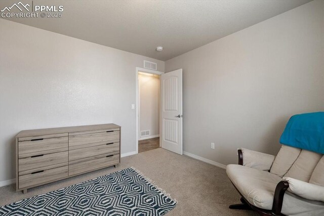 13424 Stone Valley Dr, Peyton, CO 80831 - living area featuring light carpet, visible vents, and baseboards