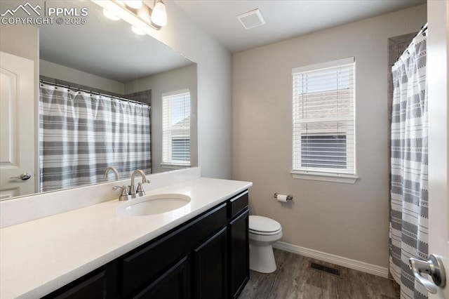 13424 Stone Valley Dr, Peyton, CO 80831 - full bathroom featuring visible vents, baseboards, wood finished floors, and a healthy amount of sunlight