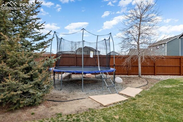 13424 Stone Valley Dr, Peyton, CO 80831 - view of yard featuring a fenced backyard and a trampoline