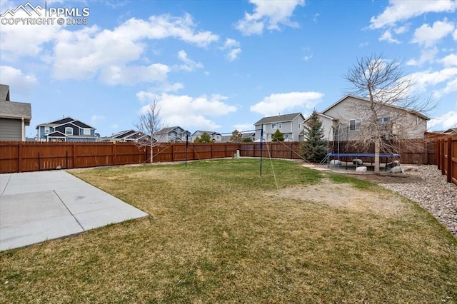 13424 Stone Valley Dr, Peyton, CO 80831 - view of yard featuring a trampoline, a patio area, a fenced backyard, and a residential view