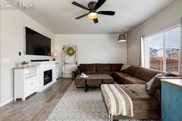 13424 Stone Valley Dr, Peyton, CO 80831 - living room with a fireplace, a ceiling fan, and wood finished floors