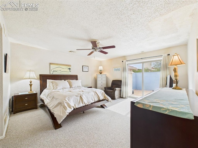 bedroom featuring a textured ceiling, visible vents, a ceiling fan, light carpet, and access to exterior
