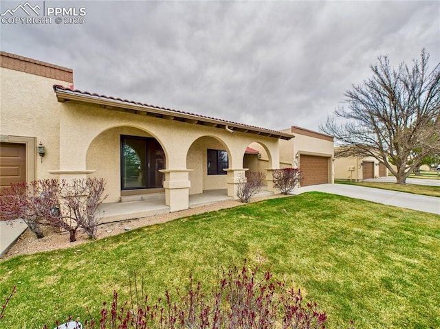 mediterranean / spanish-style home featuring stucco siding, an attached garage, a front lawn, and concrete driveway