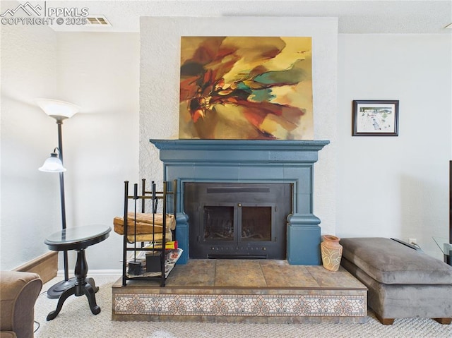 room details featuring carpet floors, baseboards, and a tile fireplace
