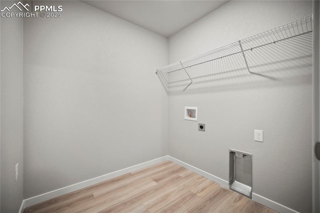 laundry area with hookup for an electric dryer, baseboards, light wood-style floors, laundry area, and washer hookup