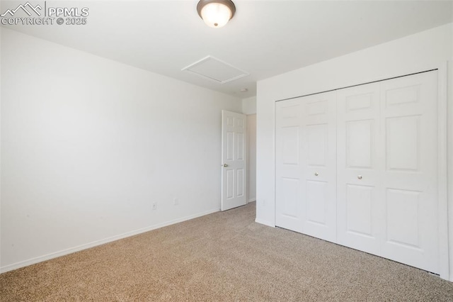 3841 Sonoran Dr, Colorado Springs, CO 80922 - unfurnished bedroom with a closet, attic access, baseboards, and carpet floors