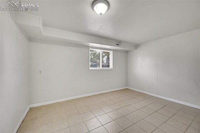 spare room with baseboards and visible vents