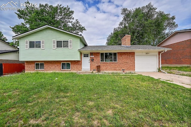 tri-level home featuring a front lawn, an attached garage, brick siding, and concrete driveway