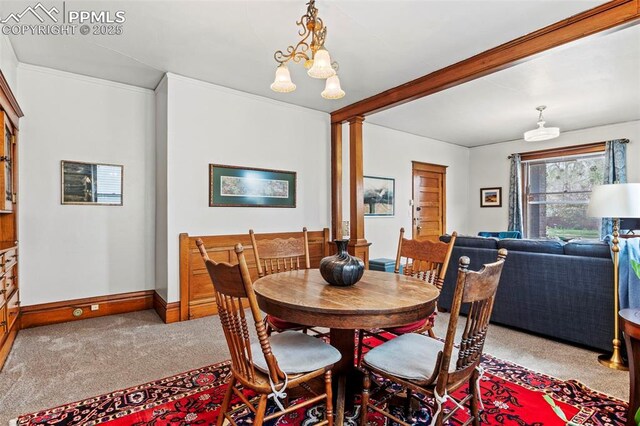 1336 N Weber St, Colorado Springs, CO 80903 - dining space with baseboards, carpet, and a notable chandelier