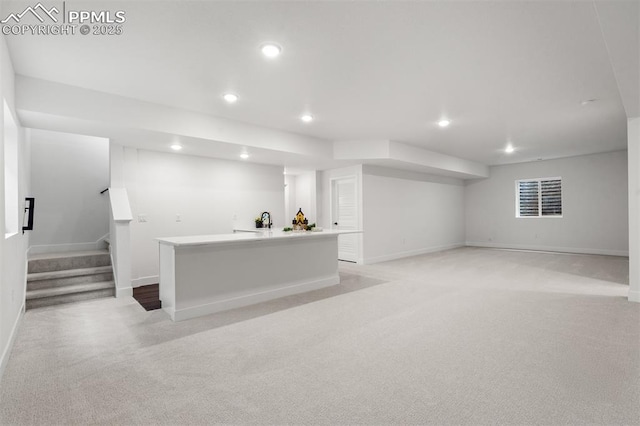 6678 Thimble Ct, Colorado Springs, CO 80924 - finished below grade area with light carpet, recessed lighting, baseboards, stairs, and a sink
