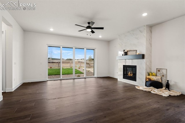 6678 Thimble Ct, Colorado Springs, CO 80924 - unfurnished living room featuring a ceiling fan, dark wood-style flooring, a high end fireplace, baseboards, and recessed lighting