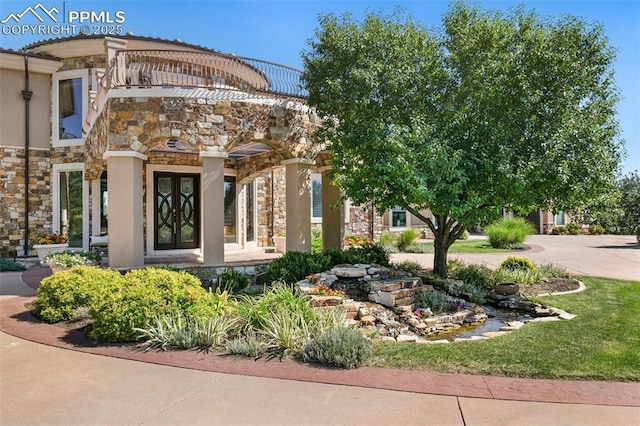 3870 S Club Dr, Colorado Springs, CO 80906 - property entrance with french doors, stone siding, and stucco siding