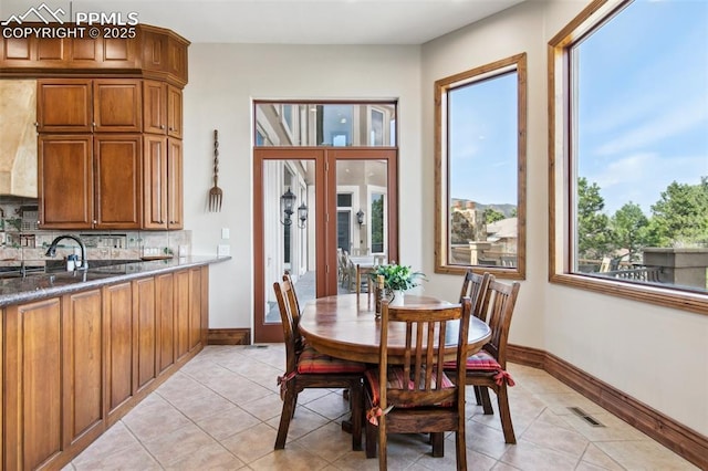 3870 S Club Dr, Colorado Springs, CO 80906 - dining area featuring light tile patterned floors, visible vents, and baseboards