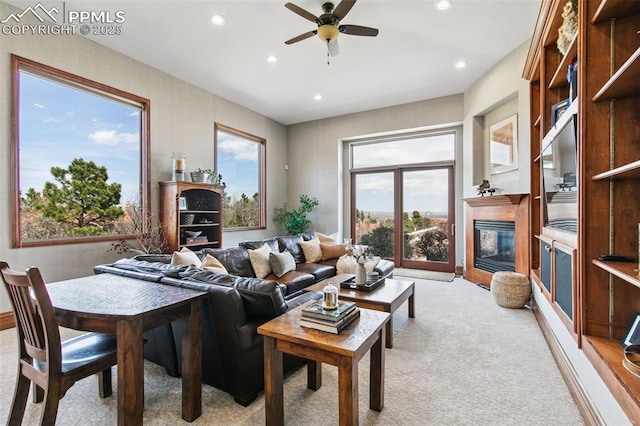 3870 S Club Dr, Colorado Springs, CO 80906 - living area with ceiling fan, recessed lighting, a glass covered fireplace, and light carpet
