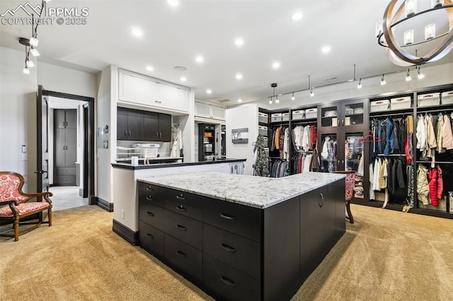 3870 S Club Dr, Colorado Springs, CO 80906 - kitchen featuring baseboards, recessed lighting, white cabinetry, dark cabinetry, and light colored carpet