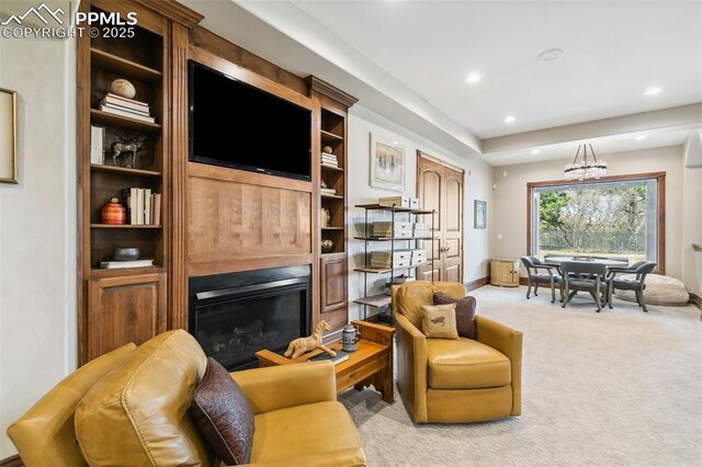 3870 S Club Dr, Colorado Springs, CO 80906 - living room with an inviting chandelier, light colored carpet, a glass covered fireplace, recessed lighting, and baseboards