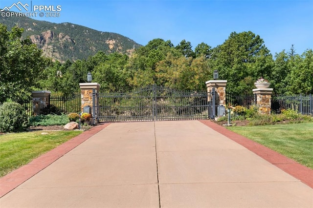 3870 S Club Dr, Colorado Springs, CO 80906 - view of gate with a yard, a mountain view, and fence