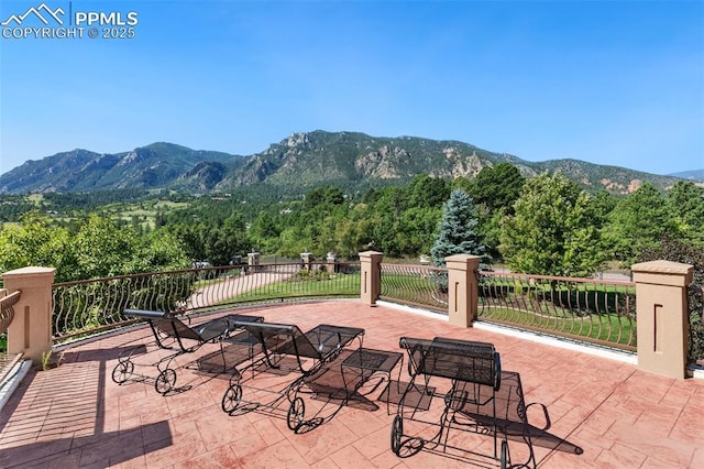 3870 S Club Dr, Colorado Springs, CO 80906 - view of patio featuring a wooded view and a mountain view
